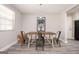 A dining room features a modern light fixture and industrial chairs around a wooden table at 1887 King Charles Sw Rd, Atlanta, GA 30331