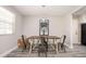 Dining room featuring modern light fixture, wood table, and stylish seating at 1887 King Charles Sw Rd, Atlanta, GA 30331