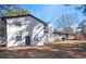 Lovely, updated two-story home with white siding, black trim, and a brick chimney at 1887 King Charles Sw Rd, Atlanta, GA 30331