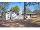 Lovely, updated two-story home with white siding, black trim, and a brick chimney at 1887 King Charles Sw Rd, Atlanta, GA 30331
