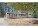 Side view of a well-maintained ranch home showcasing the attached garage and the charming brick exterior with black shutters at 1887 King Charles Sw Rd, Atlanta, GA 30331