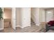 Bright hallway featuring wood-look tile flooring, white doors, and stairs leading to another level of the home at 1887 King Charles Sw Rd, Atlanta, GA 30331