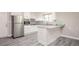 Bright kitchen features white cabinets, stainless steel appliances, granite countertops, and wood-look tile floors at 1887 King Charles Sw Rd, Atlanta, GA 30331