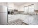 Well-designed kitchen with stainless steel appliances, white cabinetry and granite countertops at 1887 King Charles Sw Rd, Atlanta, GA 30331