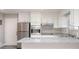 Bright kitchen features white cabinets, stainless steel appliances, granite countertops, and wood-look tile floors at 1887 King Charles Sw Rd, Atlanta, GA 30331
