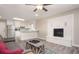 Open living area featuring wood floors, white brick fireplace, ceiling fan, and modern kitchen at 1887 King Charles Sw Rd, Atlanta, GA 30331