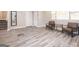 A spacious living room features wood-look flooring, neutral walls, and two chairs with a table at 1887 King Charles Sw Rd, Atlanta, GA 30331