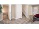 Spacious living area with neutral walls, grey floors, multiple doors, and stair access at 1887 King Charles Sw Rd, Atlanta, GA 30331