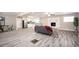 Spacious living area with open floor plan, wood-look floors, modern kitchen, and plenty of natural light at 1887 King Charles Sw Rd, Atlanta, GA 30331