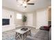 Comfortable living room showcases wood floors, white brick fireplace, gray sofa, and ceiling fan at 1887 King Charles Sw Rd, Atlanta, GA 30331