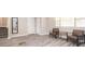 Cozy living area with wood-look tile flooring, two leather chairs, and two windows letting in plenty of natural light at 1887 King Charles Sw Rd, Atlanta, GA 30331