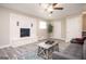 Living area with brick fireplace, gray-toned flooring, and lots of natural light creating a cozy atmosphere at 1887 King Charles Sw Rd, Atlanta, GA 30331