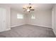 A spacious bedroom boasts a ceiling fan, plush carpeting, and large windows for plenty of natural light at 1887 King Charles Sw Rd, Atlanta, GA 30331