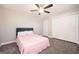 A bright bedroom features neutral paint, gray carpeting, windows, and a ceiling fan at 1887 King Charles Sw Rd, Atlanta, GA 30331