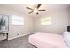 A bright bedroom featuring neutral paint, gray carpeting, windows, and a cactus picture on the wall at 1887 King Charles Sw Rd, Atlanta, GA 30331