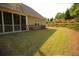 A spacious backyard with manicured lawn and landscaped hillside, perfect for outdoor activities and relaxation at 2706 Park Land Ln, Snellville, GA 30078