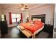 A traditionally decorated bedroom features hardwood floors and a ceiling fan at 2706 Park Land Ln, Snellville, GA 30078