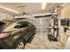 A 2-car garage features an epoxy floor, cabinets, microwave, and workout equipment at 2706 Park Land Ln, Snellville, GA 30078