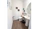 A quaint half bathroom with pedestal sink and modern décor at 2706 Park Land Ln, Snellville, GA 30078