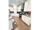 Bright kitchen boasts white cabinets, stainless steel appliances and granite counters at 2706 Park Land Ln, Snellville, GA 30078