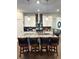 Kitchen island featuring pendant lighting, granite countertops, and bar stool seating at 2706 Park Land Ln, Snellville, GA 30078