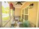 The screened-in porch features wicker seating, a ceiling fan, and serene views at 2706 Park Land Ln, Snellville, GA 30078