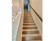 A carpeted stairway with a dark wood railing leads upstairs to the next level at 2706 Park Land Ln, Snellville, GA 30078