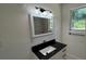 Stylish bathroom with a black granite vanity, modern fixtures, and a large window at 5510 Mason Rd, Atlanta, GA 30349
