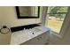 Bathroom features marble countertop, black fixtures, and a view at 5510 Mason Rd, Atlanta, GA 30349