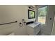 Elegant bathroom with a marble countertop vanity, black fixtures, and contemporary lighting at 5510 Mason Rd, Atlanta, GA 30349