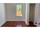 Cozy bedroom features hardwood floors, neutral walls, and a window that overlooks the backyard at 5510 Mason Rd, Atlanta, GA 30349