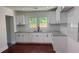 Well-lit kitchen features new white cabinets, stone countertops, and modern fixtures at 5510 Mason Rd, Atlanta, GA 30349