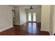 Bright living room boasts gleaming hardwood floors and a glass-paneled door for natural light at 5510 Mason Rd, Atlanta, GA 30349