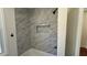 Bright and airy shower with marble-look tile and modern fixtures at 5510 Mason Rd, Atlanta, GA 30349