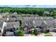 An aerial view of a neighborhood showing roof lines, green space and a red car in the driveway at 828 Olmsted Ln, Duluth, GA 30097
