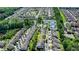 Neighborhood aerial view features community tennis courts, green space, and a property circled in yellow at 828 Olmsted Ln, Duluth, GA 30097