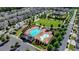 Stunning aerial view of community pool, playground, and green space surrounded by beautiful homes at 828 Olmsted Ln, Duluth, GA 30097