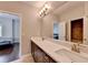 Bathroom featuring a double sink vanity, a large mirror, and neutral paint color at 828 Olmsted Ln, Duluth, GA 30097