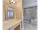 Well-lit bathroom featuring granite countertops, a tiled shower, and updated lighting fixtures at 828 Olmsted Ln, Duluth, GA 30097