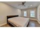 Comfortable bedroom with neutral walls, hardwood floors, fan and plenty of natural light at 828 Olmsted Ln, Duluth, GA 30097