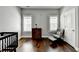 Bedroom featuring hardwood floors, a crib, an armchair and a dresser with a lamp at 828 Olmsted Ln, Duluth, GA 30097