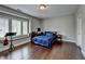 Bedroom features hardwood floors, a window seat, a desk, and a bed with blue bedding at 828 Olmsted Ln, Duluth, GA 30097