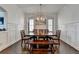 Elegant dining room with a wooden table set, a decorative chandelier, and stylish white walls at 828 Olmsted Ln, Duluth, GA 30097