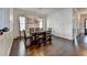 Well-lit dining area with a wooden table and bench, showcasing the home's hardwood floors at 828 Olmsted Ln, Duluth, GA 30097