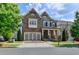 Charming two-story home featuring a covered porch, attached garage and manicured lawn at 828 Olmsted Ln, Duluth, GA 30097
