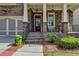 Inviting front porch with rocking chairs, brickwork and manicured landscaping at 828 Olmsted Ln, Duluth, GA 30097