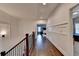 A bright hallway with hardwood floors, wainscoting, and access to multiple bedrooms at 828 Olmsted Ln, Duluth, GA 30097