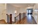A bright hallway with hardwood floors, wainscoting, and a view into the bedroom at 828 Olmsted Ln, Duluth, GA 30097