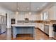 Well-lit kitchen featuring stainless steel appliances, a center island, and a tile backsplash at 828 Olmsted Ln, Duluth, GA 30097