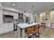 Kitchen featuring an island with seating, stainless steel appliances, and modern lighting at 828 Olmsted Ln, Duluth, GA 30097